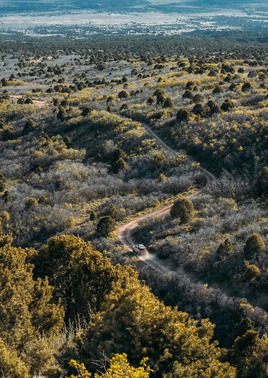 Aerial view of a dirt road through coastal hills