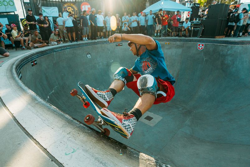 Skater in a concrete bowl at a contest